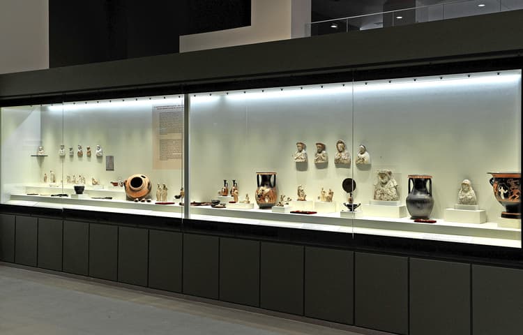 Vitrine of figurines and painted vases in the exhibition hall