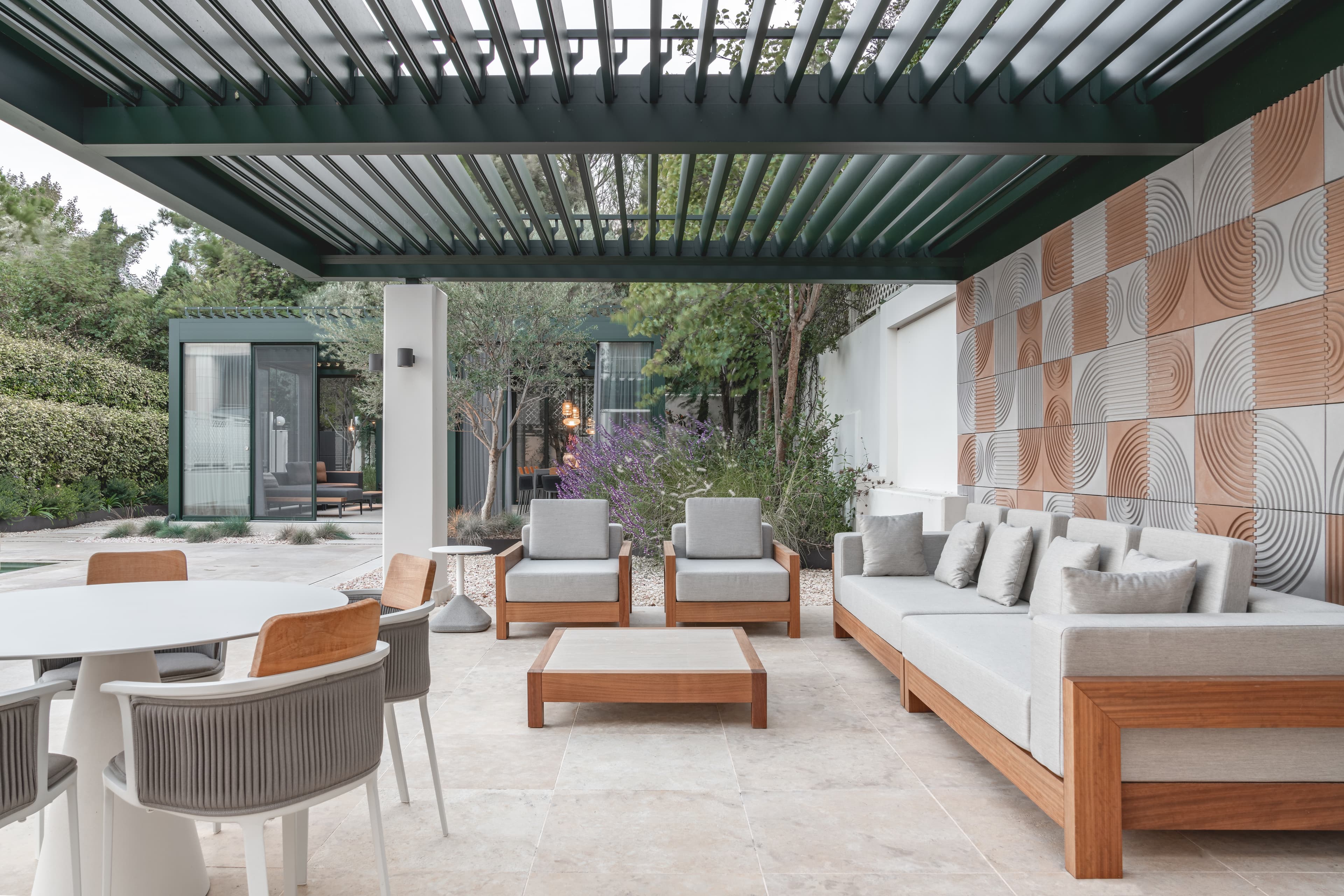 The open-air living room beneath its pergola