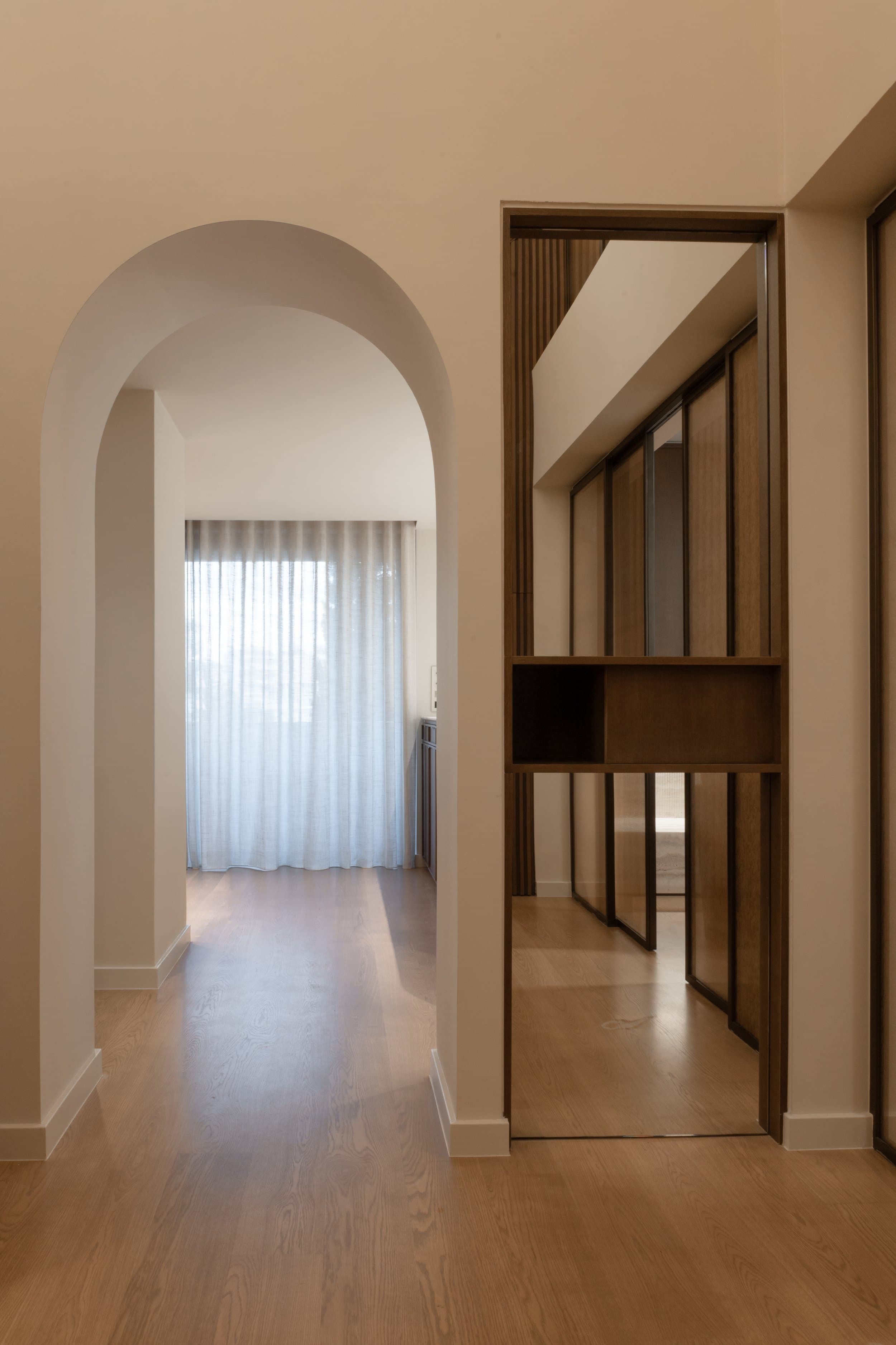 Arched hallway and sliding glass partition