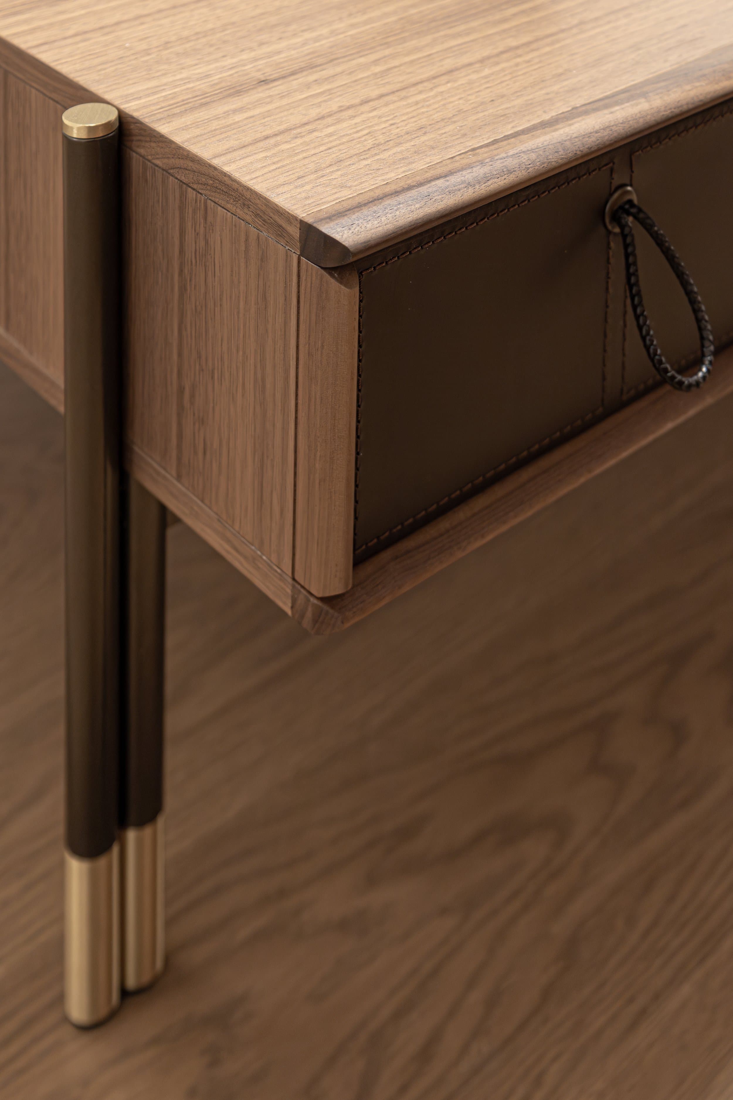 Walnut nightstand with leather pull and brass-tipped legs
