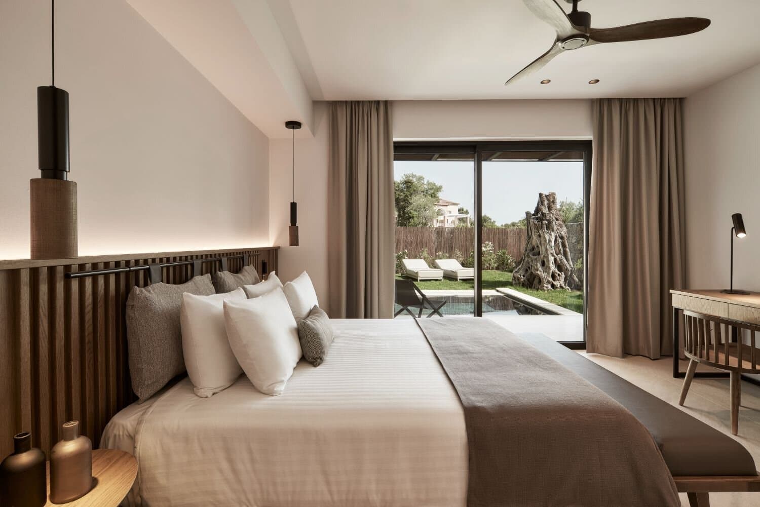 Suite bedroom opening to a private courtyard pool