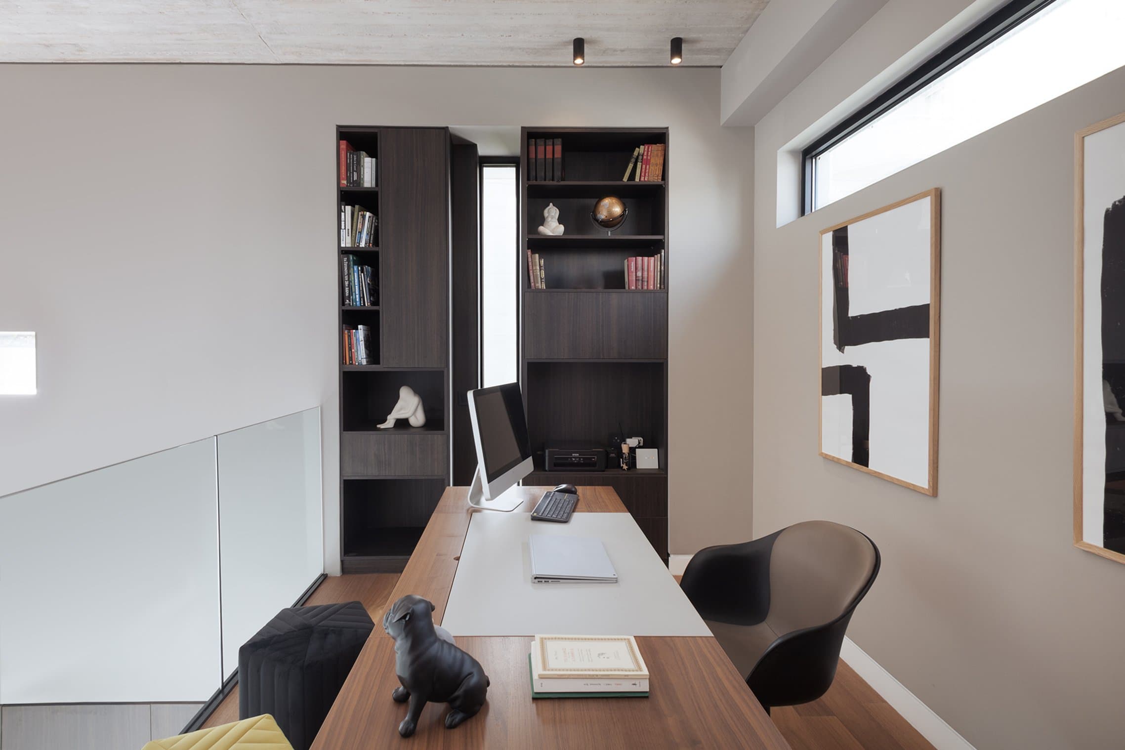Mezzanine office enclosed by glass balustrades